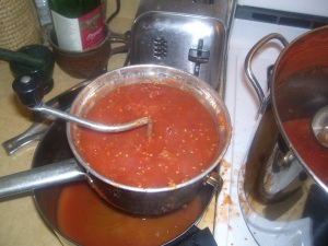 Straining tomatoes with hand strainer